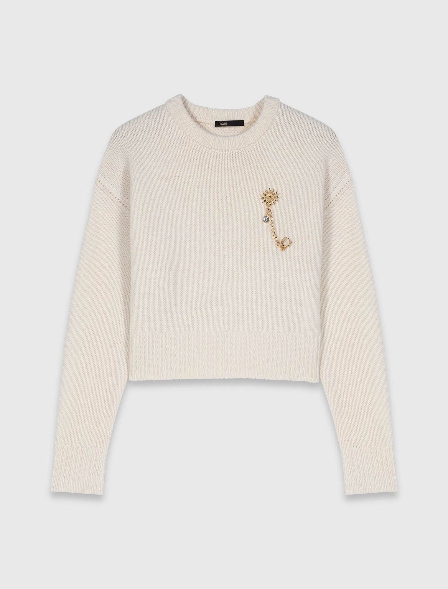 Jersey con broche floral